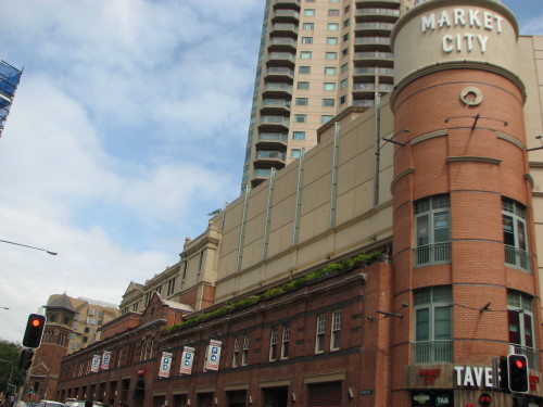 Old wharf and docks building with high rise apartments now built behind them