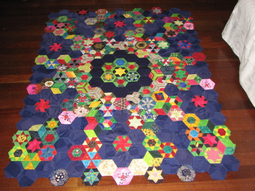 Have ruined quilt top around so you can see this end hexagons as wel
