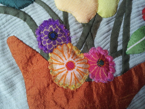I have used button hole stitch to appliqué these flowers using bottom line thread which is very very fine.