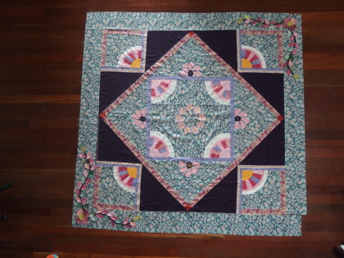 Final border is not sewn on just lying there with t he flowers and leaves lying there too 