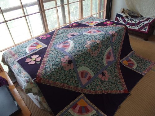 My Japanese quilt adding those large heart flowers on to the deep purple triangles. 