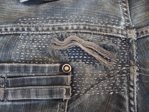 Patched jeans using sashiko stitching.