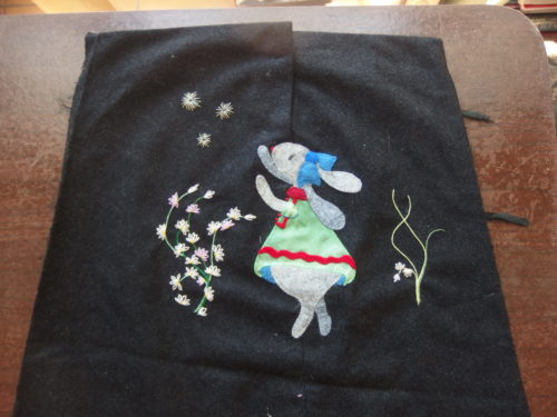 Annabelle is stitched to what was the end of a woollen coat sleeve 