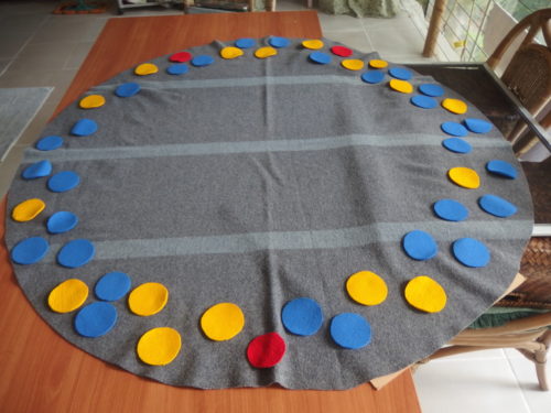 I was not happy with the shape of the blanket for the design I had been thinking of, so out came the scissors and I made a huge circle and started adding little circles. 