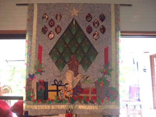 This wall quilt was designed by Esther Aliu several years ago it was a mystery BOM and all who made it had so much fun and ended up with a stunning Christmas wall hanging my family look forward to seeing it go up each year now. 