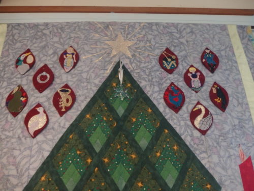 Its very cloudy out side at present so dark inside have taken a couple of close ups for those who want to have a good look LOL those 12 days before Christmas appliqués are free standing so can be removed if one ever wanted to wash the quilt. 