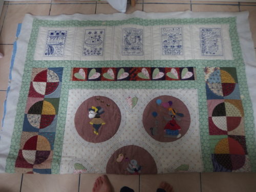Top 1/2 of Sara's quilt almost completely quilted 4 circles to quilt around then that 1/2 is completed. 