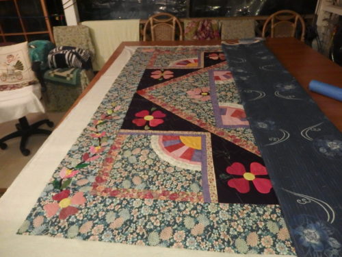 Ive completed basting the left hand side and now have turned the quilt around completely so 