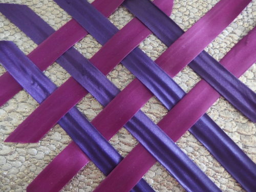 I made satin bias strips then ironed on fusing strips behind them, this made it easy to weave as I ironed the tips on to the top of the basket shape and then wove the strips till i was sure they were all woven properly. 