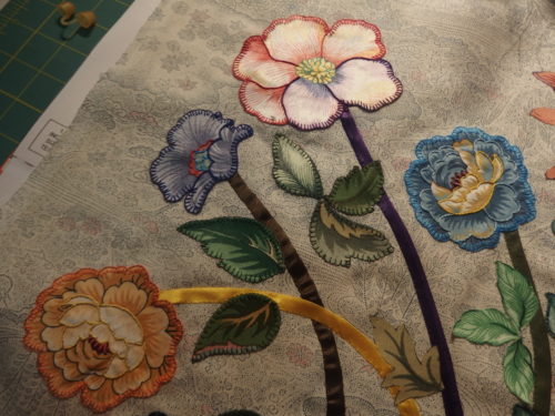 4 flowers embroidered and appliquéd down. 