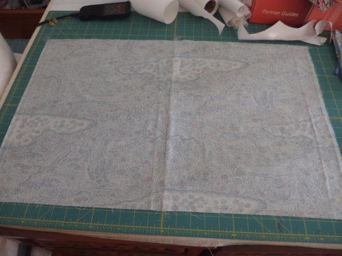 To mark my background fabric I tape it down first then lay the patte on top