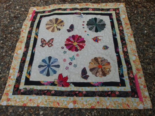 I have completed echo quilting around 3 dresden plates now and 1/2 way around the centre one 