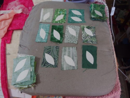 washaway freezer paper been ironed tot he abck of those wee pieces of fabric, I even managed to get two out out of a few pieces so have around 60 new leaves to baste. I have now 20 blocks completed, I need another 20 !!!!