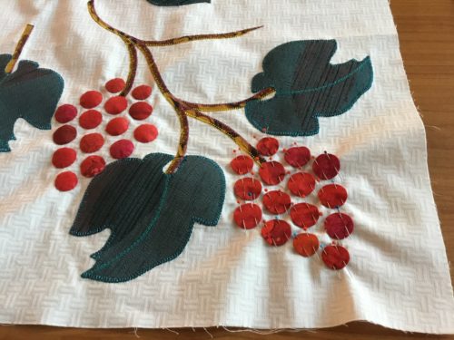 Pinning on more grapes to hand applique