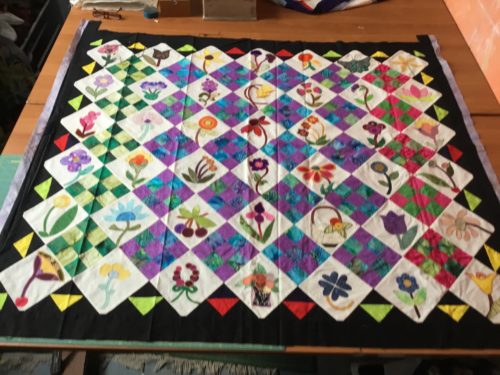 My first try at making Florence Peto’s My Calico Garden about 12 years ago in very bright colours??? I then wanted to add a different border too? 11 flower blocks on the left 2 panels were done by other quilters mail swap blocks . These blocks wet e 6inchs not 4 1/2 inches finished . 
