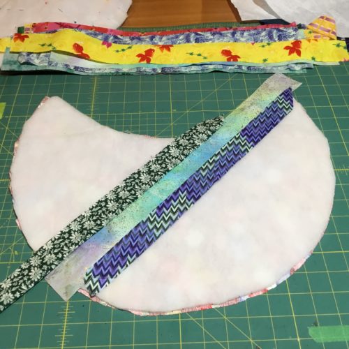 Add another strip of fabric to the right hand side of the 1 strip of fabric and sew down 
