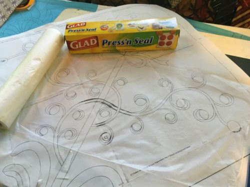 Cling wrap is laid on top of pattern and then with a fine permanent marker I draw the pattern to the cling wrap! 